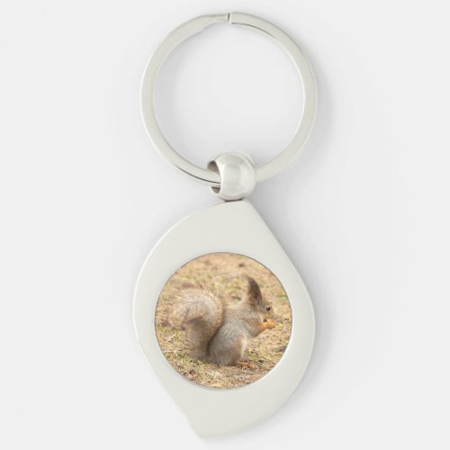 Cute squirrel eats a nut photo keychain