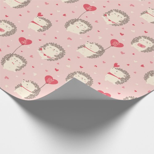 Cute valentines hedgehogs with hearts on pink wrapping paper