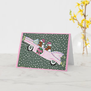 Dachshunds at Christmas in a pink convertible Card