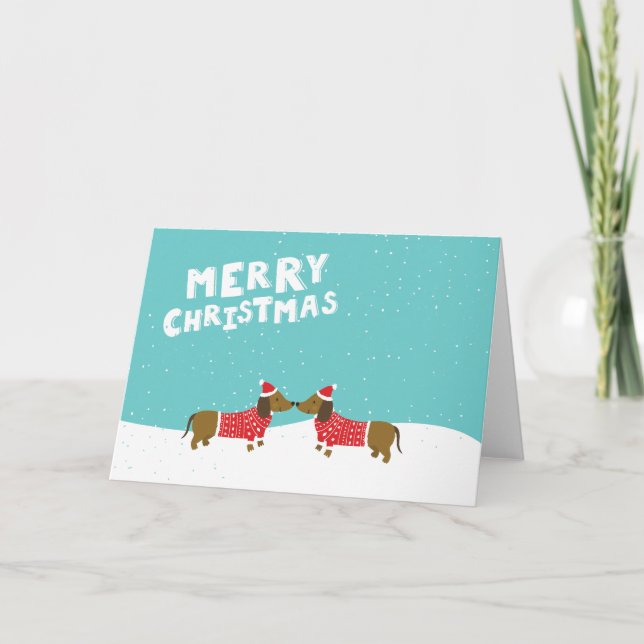 Dachshunds kissing in the snow Merry Christmas Holiday Card (Front)