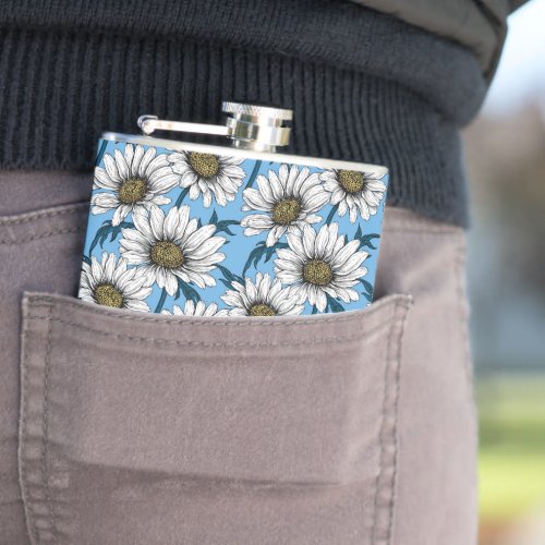Daisies wild flowers on blue flask