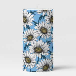 Daisies, wild flowers on blue pillar candle