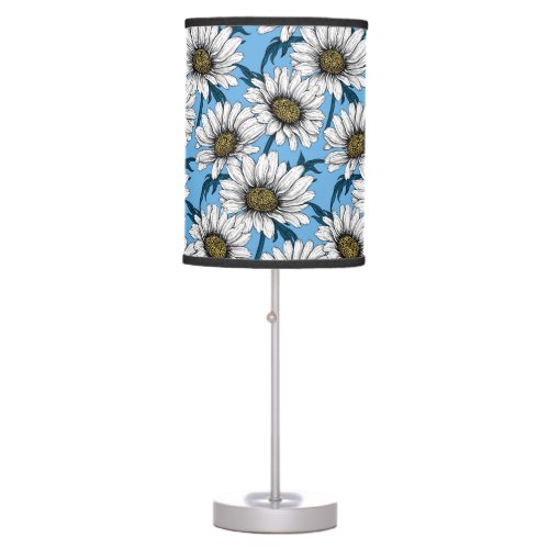 Daisies wild flowers on blue table lamp