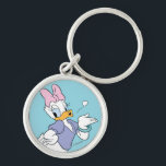 Daisy Duck Blowing a Kiss Keychain<br><div class="desc">Spread a little love with this timeless and charming Daisy Duck character graphic! Captured in a classic, flirtatious pose blowing a delicate heart-shaped kiss, this design radiates sweetness and personality. With her iconic pink bow, purple blouse, and matching heels, this illustration is a beautiful celebration of classic animation style. The...</div>