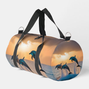 Dancing in the Dusk: Three Dolphins Leaping  Duffle Bag