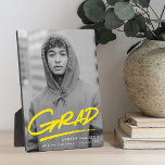 Dashed Yellow Graduation Photo Plaque<br><div class="desc">Celebrate your graduate’s achievement with a personalized graduation photo keepsake featuring their vertical photo and the word “Grad” in bright yellow handwritten lettering with a stylish dash below. This vibrant and modern graduation plaque can be customized with the graduate’s name, school, and graduation year, making it a meaningful and cheerful...</div>