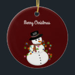 Dated Merry Christmas Snowman Personalized Ceramic Ornament<br><div class="desc">Cute snowman is tangled with lit Christmas lights, has the year on his hat - The "Merry Christmas" text above can be changed or added to, and the font style/size can also be changed. Shown on a deep red background, which can be changed to any color you prefer. The ornament...</div>