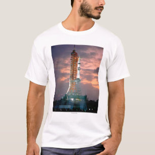 Dawn breaks behind ASTP Saturn IB CDDT T-Shirt