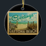 Daytona Beach Vintage Travel Ceramic Ornament<br><div class="desc">This Greetings From Daytona Beach vintage postcard design features a sandy beach with a beautiful turquoise ocean water and above the sea,  a blue sky with billowy white clouds. In vintage travels style.</div>