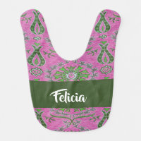 Decorative green flowers on pink baby bib