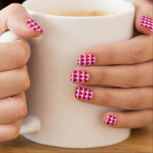 Deep rose red hearts on a pale pink background minx nail art