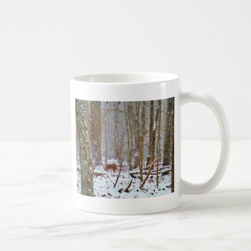 Deer in the snow licking leg coffee mug