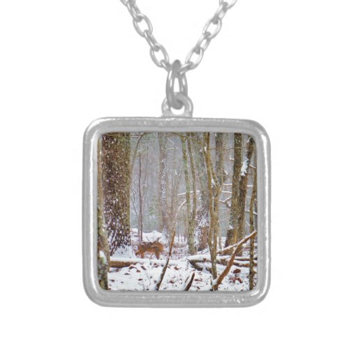 Deer in the snow licking leg silver plated necklace