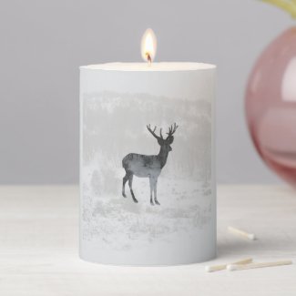 Deer silhouette on a winter snowing forest pillar candle