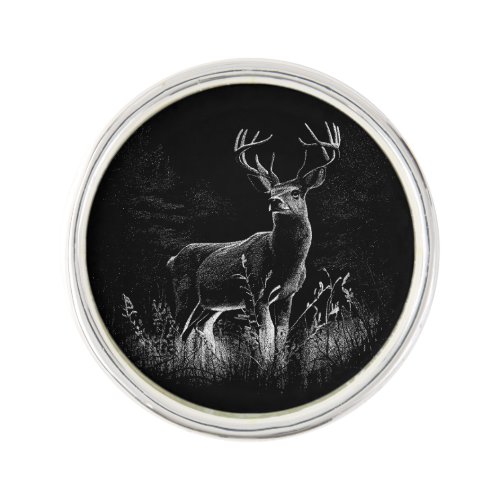 Deer with antlers framed by field and tree      lapel pin