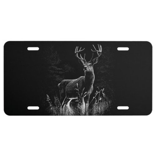 Deer with antlers framed by field and tree     license plate