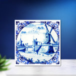 Delft Blue Windmill Bridge and Waterways Ceramic Tile<br><div class="desc">Beautiful,  blue and white,  hand painted,  delft blue,  vintage,  Holland windmill and bridge over their unique waterways.  Ornate,  floral,  round,  border frames which is very noteable in delftware.</div>