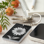 Delicate Black & White Daisy  Keychain<br><div class="desc">A timeless keepsake for unforgettable celebrations. This elegant black and white daisy keychain makes the perfect party favor for Quinceañeras and Sweet 16s. With a vintage floral design and personalized name option, it’s a thoughtful gift that guests will treasure long after the party ends. Customize the background color and font...</div>