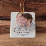 Delicate First Christmas Engaged Photo Ceramic Ornament<br><div class="desc">This delicate first Christmas engaged photo ceramic ornament is the perfect modern Christmas tree decoration. The romantic minimalist design features lovely and elegant black typography with a clean and simple look. This keepsake ornament reads "first Christmas engaged". Personalize your double-sided ornament with your engagement photo,  names and the year.</div>