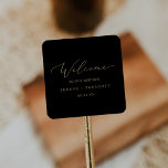 Delicate Gold Calligraphy | Black Wedding Welcome Square Sticker<br><div class="desc">These delicate gold calligraphy black wedding welcome stickers are perfect for a modern wedding. The romantic minimalist design features lovely and elegant champagne golden yellow typography on a black background with a clean and simple look. Personalize these stickers with the location of your wedding, names, and wedding date. These labels...</div>