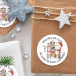 Delivered by Santa and Reindeer Classic Round Sticker<br><div class="desc">Christmas stickers for kids gifts,  lettered with "wrapped by elves,  delivered by Santa & reindeer",  in whimsical typography,  which you can edit if you wish. The cute watercolor illustration has Santa Claus with his reindeer and sleigh filled with presents.</div>