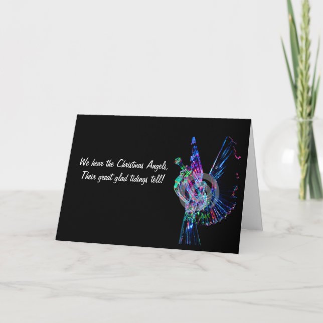 Depicts a lighted angel blowing a trumpet  holiday card (Front)