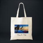 Destination wedding = customize with your own name tote bag<br><div class="desc">Relaxing beach scene with tiki huts and party drinks with umbrellas and palm trees.  Perfect decor for destination weddings.</div>
