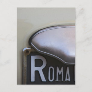 detail of a Roma number plate on a small Italian Postcard