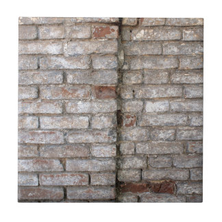 Detail of a wall of an old red brick with white co tile