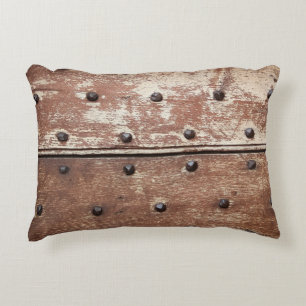 Detail of an old painted shabby door with rusty me accent pillow
