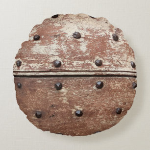Detail of an old painted shabby door with rusty me round pillow