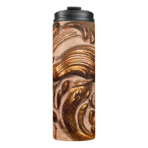 detail of ornamental picture frame, bronze color. thermal tumbler