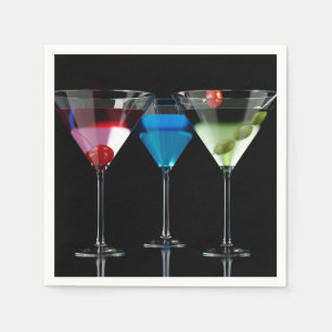 Different cocktails in martini glasses on black napkins