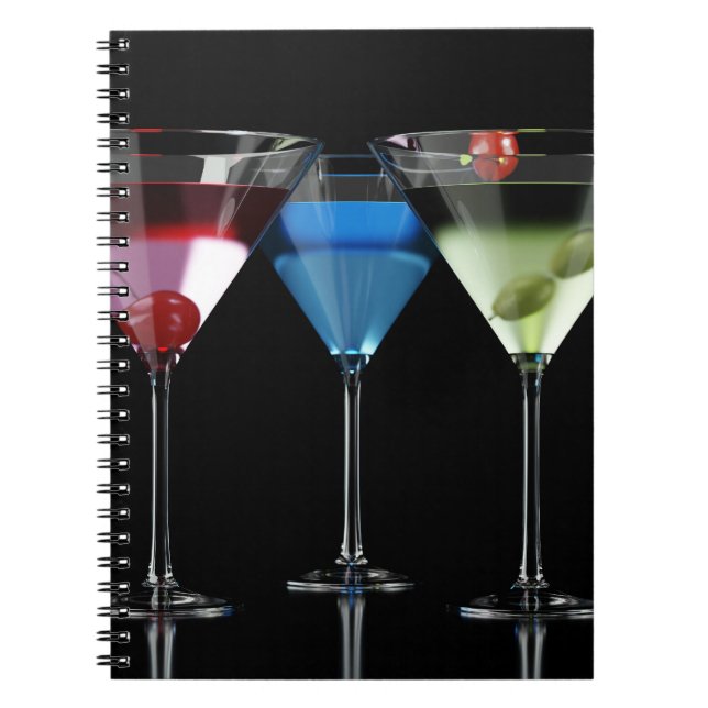 Different cocktails in martini glasses on black notebook (Front)