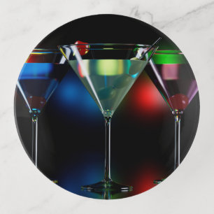 Different cocktails in martini glasses with lights trinket tray