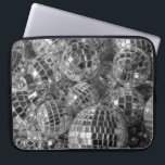 Disco Ball Ornaments Laptop Sleeve<br><div class="desc">Disco ball ornaments of various sizes form a chaotic pile in this unique black and white photograph. The shiny mirror balls reflect bright light or dark shadows from each of their small mirrored facets. The glitter ball ornaments rest on top of garlands with reflective silver dodecahedron beads. Digital, black &...</div>