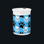 Distressed Black And White Paws On Blue Background Beverage Pitcher<br><div class="desc">A pattern in black and white of dog paw prints with distressed effects on a blue background.
Original design cartoon style</div>