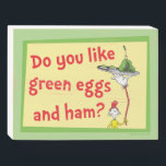 Do You Like Green Eggs and Ham? Wooden Box Sign<br><div class="desc">This authentic Dr. Seuss design features a memorable moment from the classic children's book. The fun illustration showcases the persistent Sam-I-Am playfully balancing a platter of his famous dish high above his head on a long, bending pole. It includes the iconic question, "Do you like green eggs and ham?", perfectly...</div>