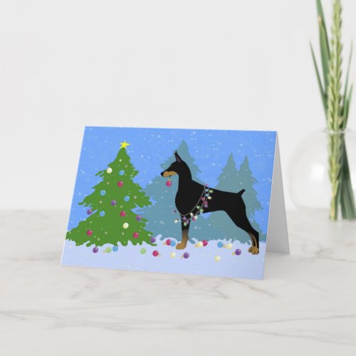 Doberman Decorating Tree in the Forest Holiday Card