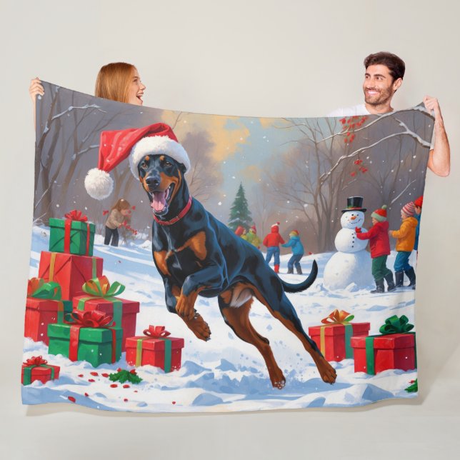 Doberman Running in Snow with Christmas Hat Fleece Blanket (In Situ)