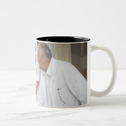 Doctor and nurse tending to patient Two_Tone coffee mug