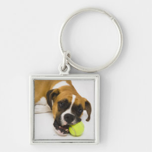 Dog biting tennis ball keychain