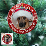 Dog First Christmas Snowflakes 2 Photo Red Ceramic Ornament<br><div class="desc">Create a personalized photo keepsake ornament for a puppy or dog with this festive red and white round ceramic ornament featuring 2 pictures (one on each side), dog pawprints and snowflakes with your custom text (the sample shows Name's First Christmas). The design is duplicated on both sides with the same...</div>