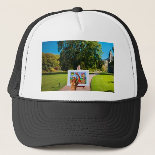 Dog Painting a Cartoon with brush in Garden Trucker Hat