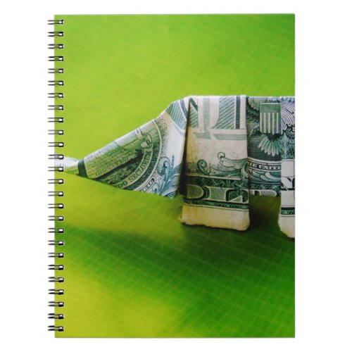 Dollar bill origami Elephant on Green background Notebook