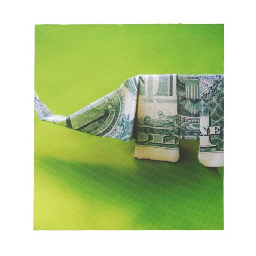 Dollar bill origami Elephant on Green background Notepad