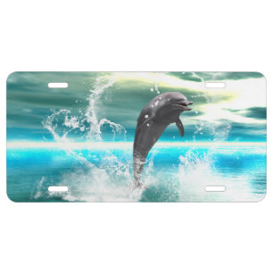 Dolphin jumping in the sea with waves as heart license plate