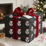 Donald Trump Santa Hat Christmas Pattern Wrapping Paper<br><div class="desc">This holiday design features a repeating portrait pattern of Donald Trump wearing a red Santa hat on a black background. The dark backdrop makes the festive red and white details stand out clearly and gives the layout a bold seasonal look. The repeating pattern style keeps the design simple, eye-catching, and...</div>