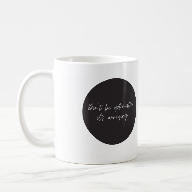 Don't be optimistic, funny saying coffee mug (Left)