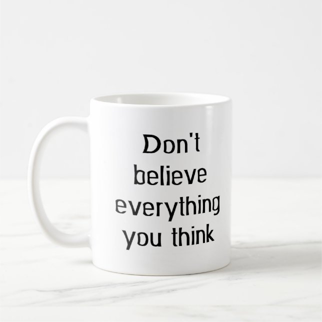 don't believe everything coffee mug (Left)